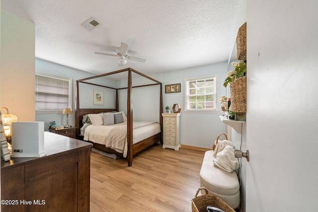 225 Candlewood Dr, Wilmington, NC 28411 - bedroom featuring light wood finished floors, a textured ceiling, and ceiling fan