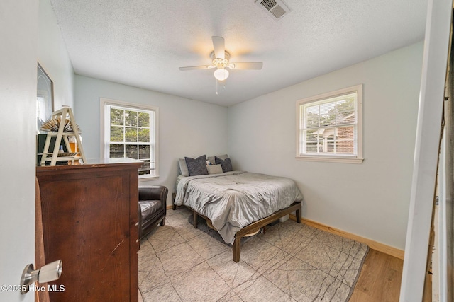 225 Candlewood Dr, Wilmington, NC 28411 - bedroom with a textured ceiling, light wood finished floors, and ceiling fan