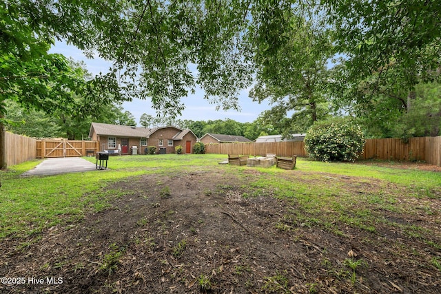 225 Candlewood Dr, Wilmington, NC 28411 - fenced backyard with a patio and a gate