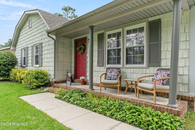 225 Candlewood Dr, Wilmington, NC 28411 - doorway to property featuring a porch, a shingled roof, and a yard