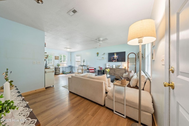 225 Candlewood Dr, Wilmington, NC 28411 - living area with light wood-style flooring, a ceiling fan, and a textured ceiling