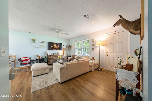 225 Candlewood Dr, Wilmington, NC 28411 - living area with ceiling fan, wood finished floors, and a textured ceiling