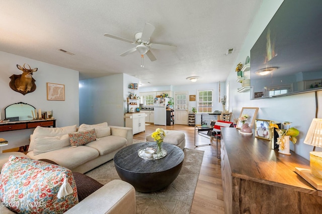 225 Candlewood Dr, Wilmington, NC 28411 - living area featuring light wood-type flooring, a ceiling fan, and a textured ceiling