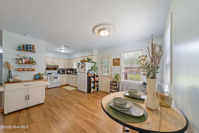 225 Candlewood Dr, Wilmington, NC 28411 - dining space with light wood-style flooring and a textured ceiling