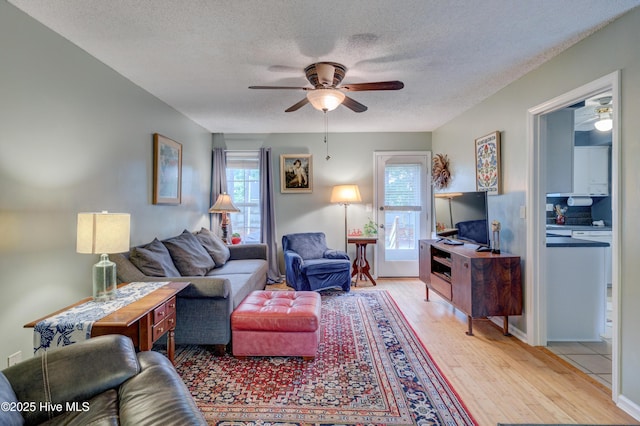 1525 Pointer Ln, Wilmington, NC 28411 - living area with ceiling fan, a textured ceiling, and light wood finished floors