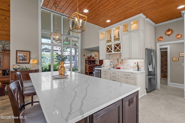 4 Lake Shore Ct, Pinehurst, NC 28374 - kitchen featuring stainless steel refrigerator with ice dispenser, wooden ceiling, a chandelier, light stone countertops, and white cabinetry