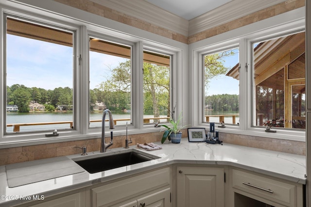 4 Lake Shore Ct, Pinehurst, NC 28374 - kitchen featuring a water view, white cabinetry, and light stone counters