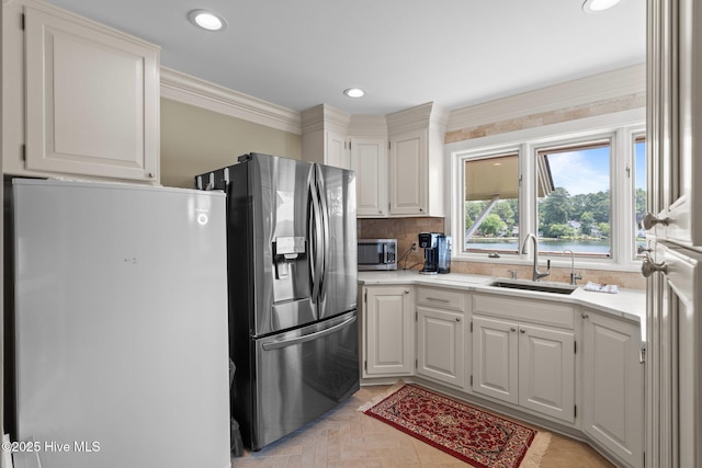 4 Lake Shore Ct, Pinehurst, NC 28374 - kitchen with stainless steel appliances, light countertops, white cabinets, decorative backsplash, and ornamental molding