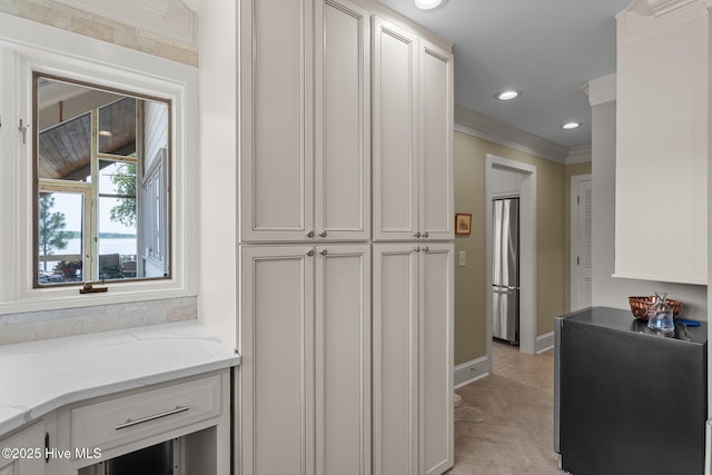 4 Lake Shore Ct, Pinehurst, NC 28374 - kitchen with ornamental molding, stainless steel refrigerator, light stone countertops, white cabinets, and recessed lighting