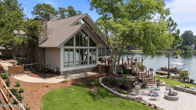 4 Lake Shore Ct, Pinehurst, NC 28374 - rear view of house featuring a patio area, a water view, a shingled roof, boat lift, and a gate