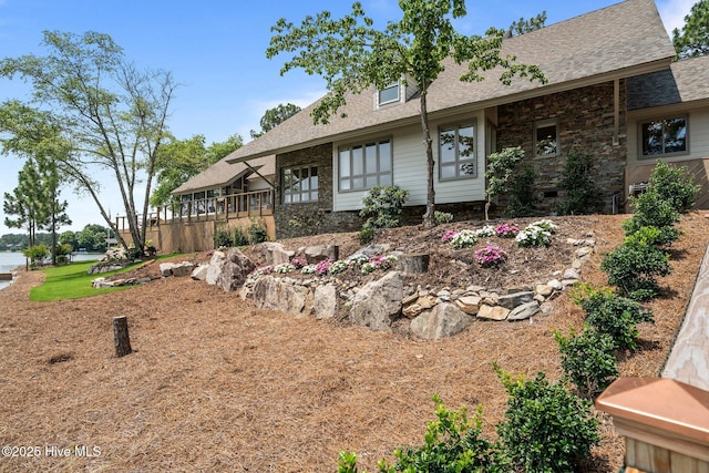 4 Lake Shore Ct, Pinehurst, NC 28374 - view of front of house featuring a shingled roof and stone siding