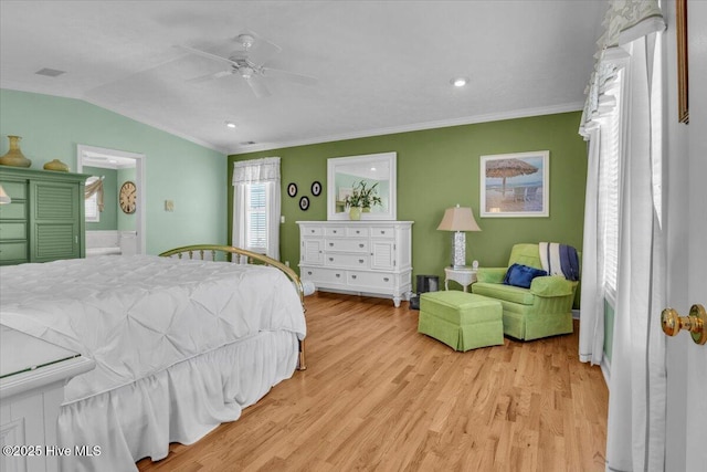 813 Cutter Ct, Kure Beach, NC 28449 - bedroom featuring light wood-style flooring, ornamental molding, lofted ceiling, connected bathroom, and ceiling fan