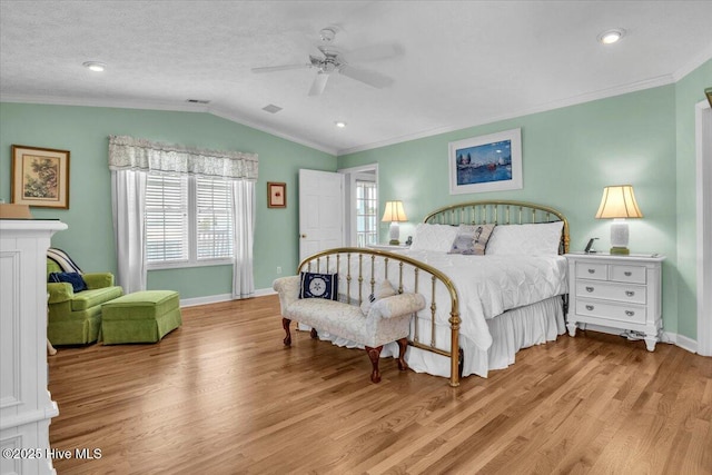 813 Cutter Ct, Kure Beach, NC 28449 - bedroom with crown molding, light wood finished floors, vaulted ceiling, and ceiling fan