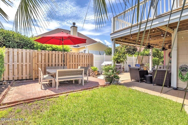 813 Cutter Ct, Kure Beach, NC 28449 - fenced backyard with a patio area, outdoor lounge area, a ceiling fan, and outdoor dining space