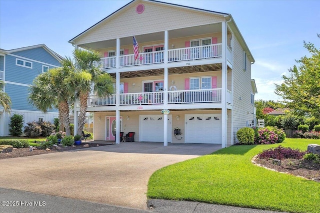 813 Cutter Ct, Kure Beach, NC 28449 - view of front facade featuring driveway, a garage, a front yard, and a balcony
