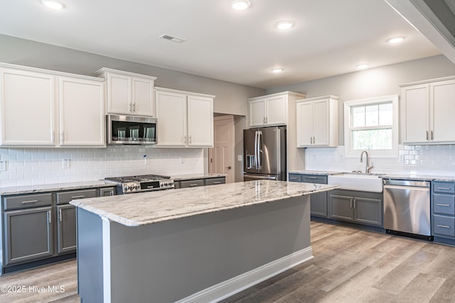 193 Jim S Rd, Cameron, NC 28326 - kitchen featuring stainless steel appliances, a sink, backsplash, light stone counters, and gray cabinets