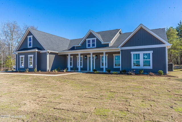 193 Jim S Rd, Cameron, NC 28326 - view of front facade with central air condition unit, a front lawn, covered porch, and roof with shingles