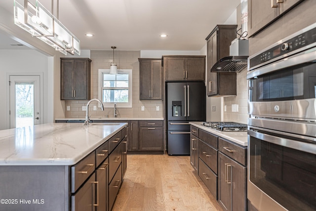 193 Jim S Rd, Cameron, NC 28326 - kitchen with stainless steel appliances, plenty of natural light, light wood finished floors, dark brown cabinetry, and recessed lighting