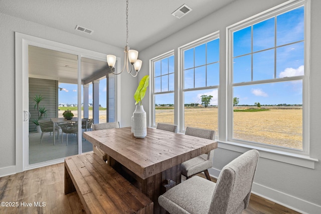 101 Claire Ct, Moyock, NC 27958 - dining space featuring baseboards, a chandelier, and wood finished floors