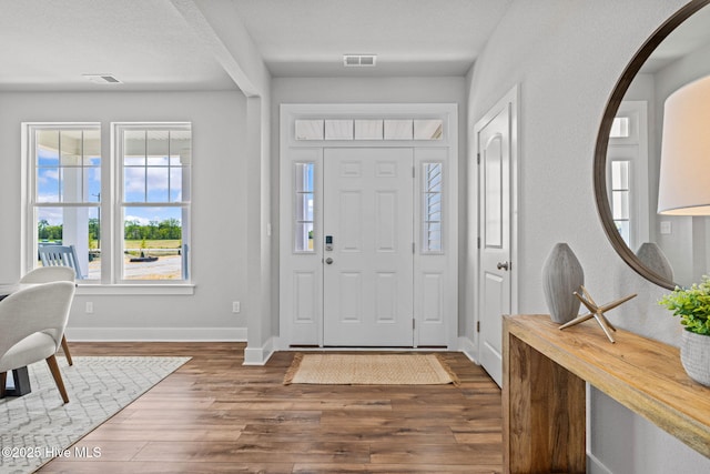 101 Claire Ct, Moyock, NC 27958 - entrance foyer with wood finished floors, baseboards, and arched walkways