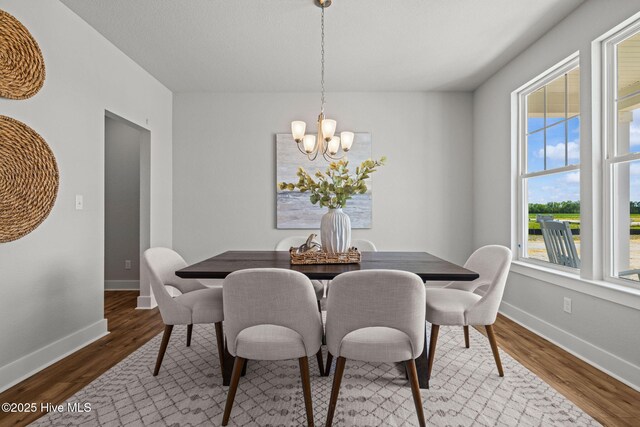 101 Claire Ct, Moyock, NC 27958 - dining area with a chandelier, wood finished floors, and baseboards