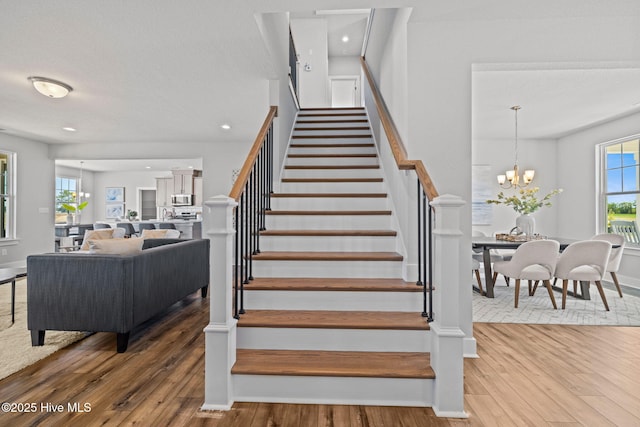 101 Claire Ct, Moyock, NC 27958 - stairway featuring wood finished floors, a chandelier, baseboards, and recessed lighting