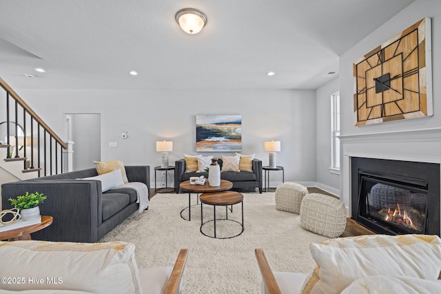 101 Claire Ct, Moyock, NC 27958 - living area featuring a glass covered fireplace, stairway, and recessed lighting