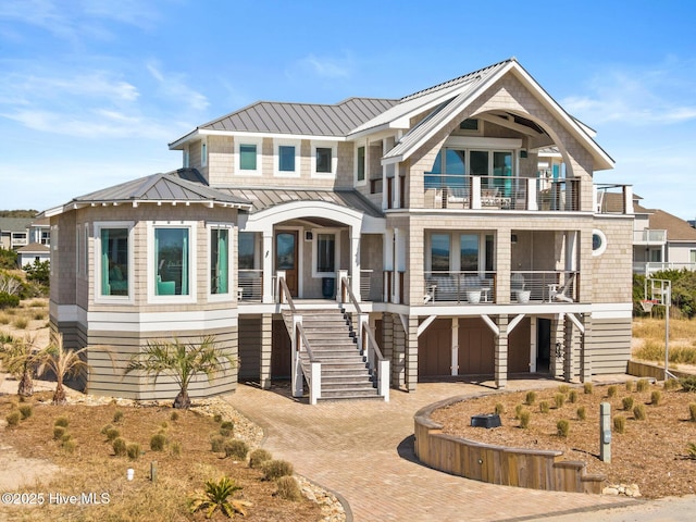 11 Sandspur Trl, Bald Head Island, NC 28461 - coastal inspired home featuring a balcony, stairs, a porch, and a standing seam roof