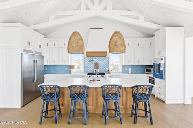 11 Sandspur Trl, Bald Head Island, NC 28461 - kitchen with stainless steel appliances, light wood-type flooring, light countertops, white cabinetry, and backsplash