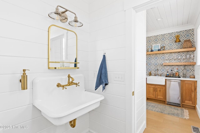 11 Sandspur Trl, Bald Head Island, NC 28461 - bathroom with crown molding, wood finished floors, and wallpapered walls