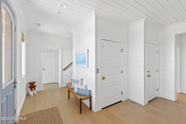 11 Sandspur Trl, Bald Head Island, NC 28461 - foyer featuring light wood-style floors, wooden ceiling, and ornamental molding