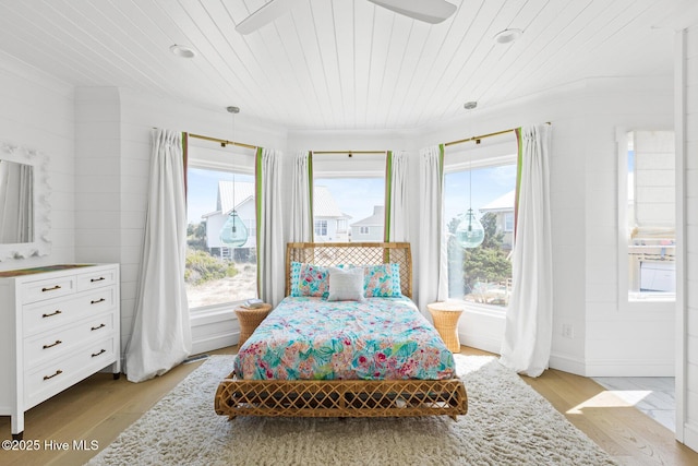 11 Sandspur Trl, Bald Head Island, NC 28461 - bedroom with wooden ceiling, multiple windows, crown molding, and light wood-type flooring