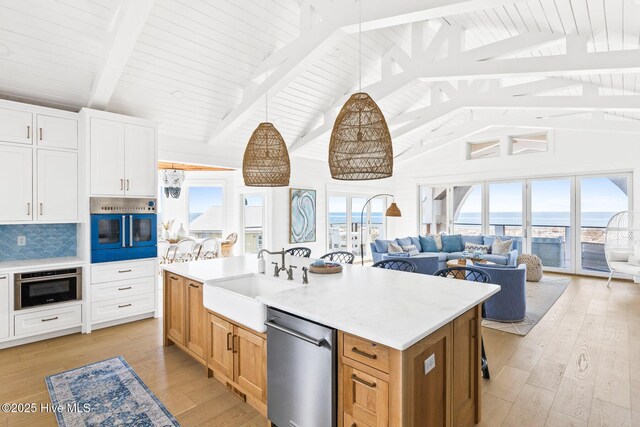 11 Sandspur Trl, Bald Head Island, NC 28461 - kitchen featuring appliances with stainless steel finishes, open floor plan, light countertops, high vaulted ceiling, and a wood ceiling with exposed beams