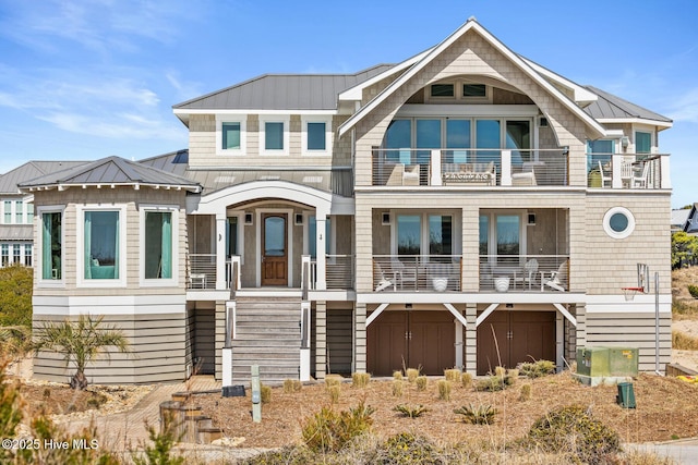 11 Sandspur Trl, Bald Head Island, NC 28461 - beach home featuring a balcony, a standing seam roof, a metal roof, and stairs