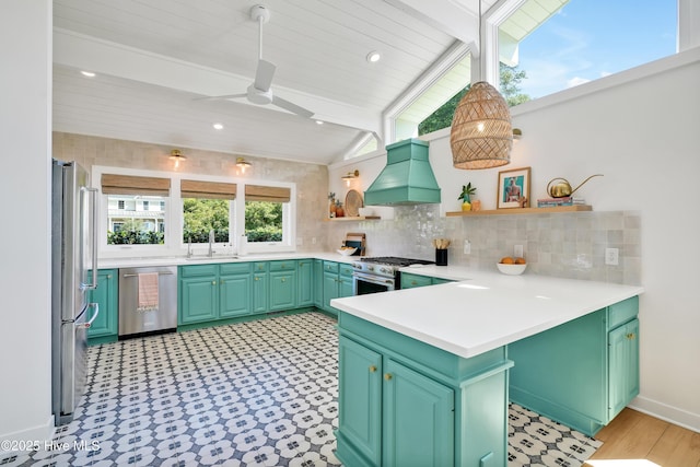 3343 Channelside Dr SW, Supply, NC 28462 - kitchen with appliances with stainless steel finishes, open shelves, custom exhaust hood, tasteful backsplash, and ceiling fan