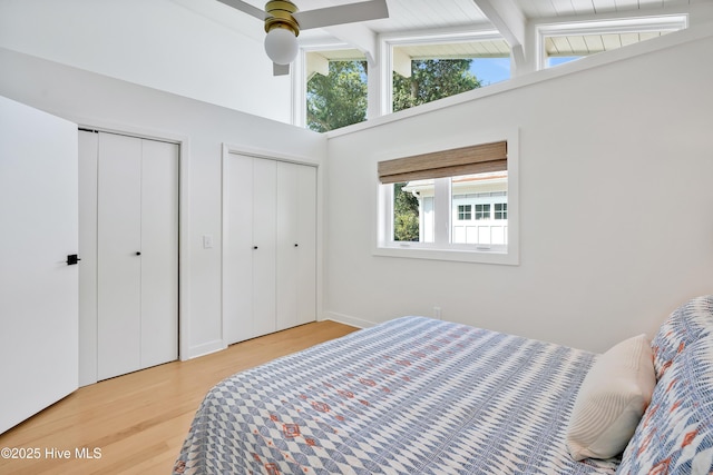 3343 Channelside Dr SW, Supply, NC 28462 - bedroom featuring multiple closets, light wood-style flooring, beam ceiling, high vaulted ceiling, and a ceiling fan