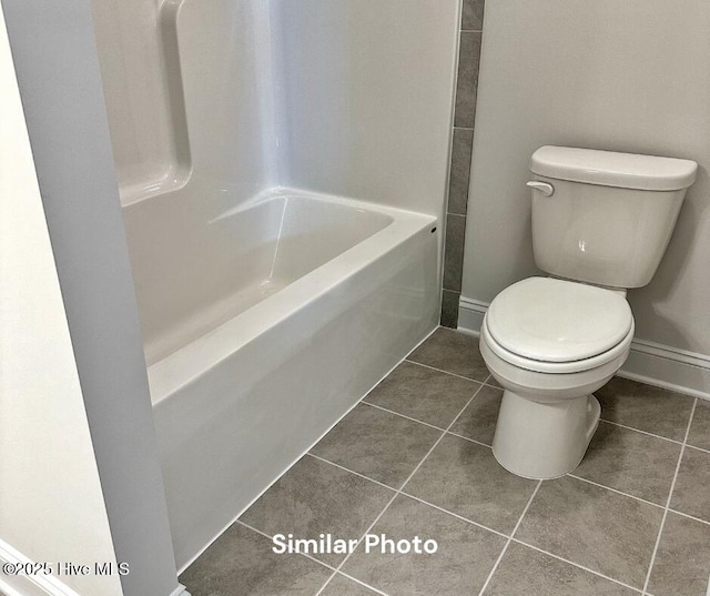1822 Olde Towne Pointe Blvd, Jacksonville, NC 28546 - bathroom featuring tile patterned floors, toilet, bathing tub / shower combination, and baseboards
