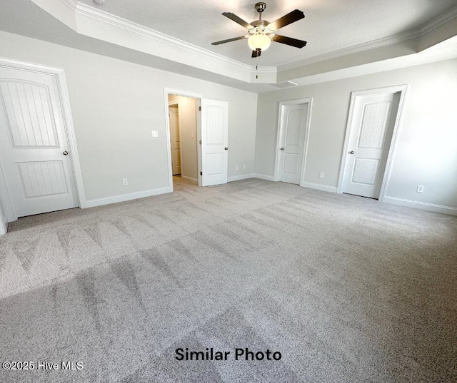 1822 Olde Towne Pointe Blvd, Jacksonville, NC 28546 - unfurnished bedroom with a tray ceiling, crown molding, baseboards, and carpet floors