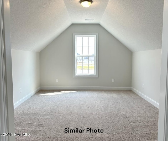 1822 Olde Towne Pointe Blvd, Jacksonville, NC 28546 - bonus room with a textured ceiling, carpet floors, baseboards, and vaulted ceiling