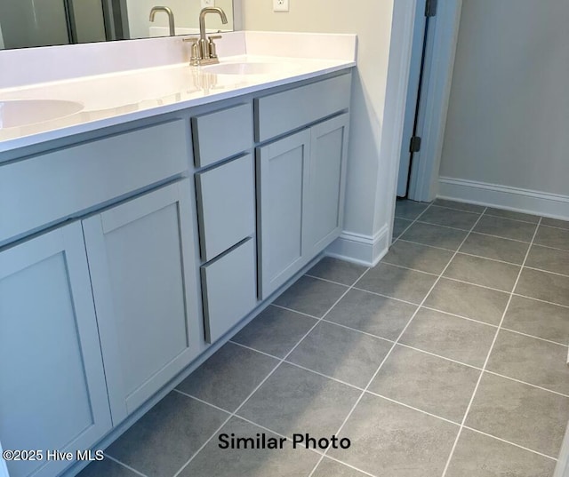 1822 Olde Towne Pointe Blvd, Jacksonville, NC 28546 - bathroom featuring tile patterned floors, double vanity, and baseboards