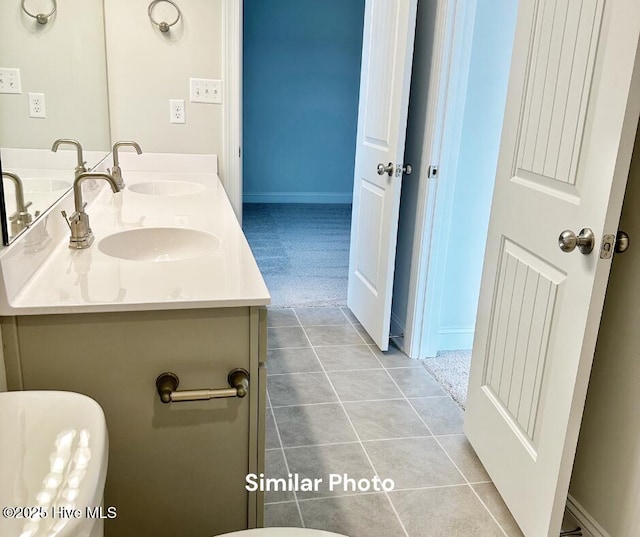 1822 Olde Towne Pointe Blvd, Jacksonville, NC 28546 - bathroom featuring double vanity, baseboards, and tile patterned floors