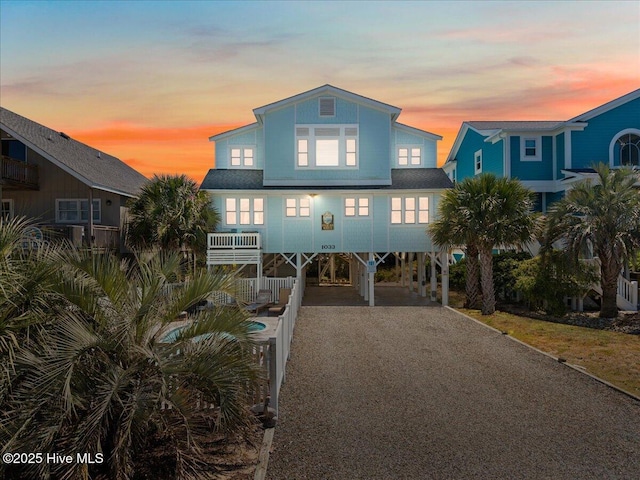 1033 Ocean Blvd W, Holden Beach, NC 28462 - coastal inspired home featuring a carport and dirt driveway