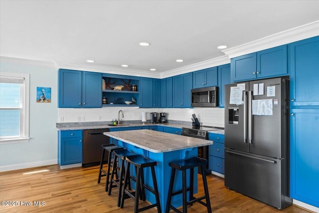 1033 Ocean Blvd W, Holden Beach, NC 28462 - kitchen with stainless steel appliances, blue cabinets, open shelves, a kitchen bar, and backsplash