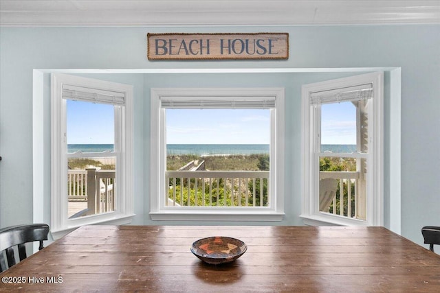 1033 Ocean Blvd W, Holden Beach, NC 28462 - dining space with ornamental molding and a water view
