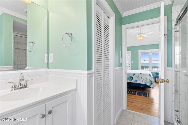1033 Ocean Blvd W, Holden Beach, NC 28462 - bathroom with a closet, ornamental molding, wainscoting, vanity, and tile patterned flooring