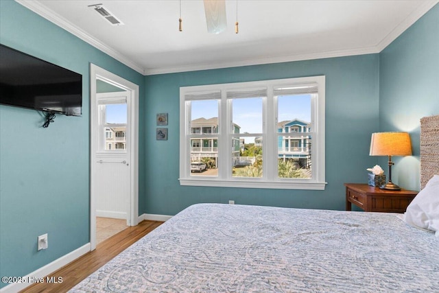 1033 Ocean Blvd W, Holden Beach, NC 28462 - bedroom featuring wood finished floors and ornamental molding