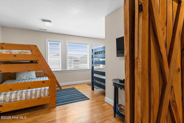 1033 Ocean Blvd W, Holden Beach, NC 28462 - bedroom featuring baseboards and wood finished floors