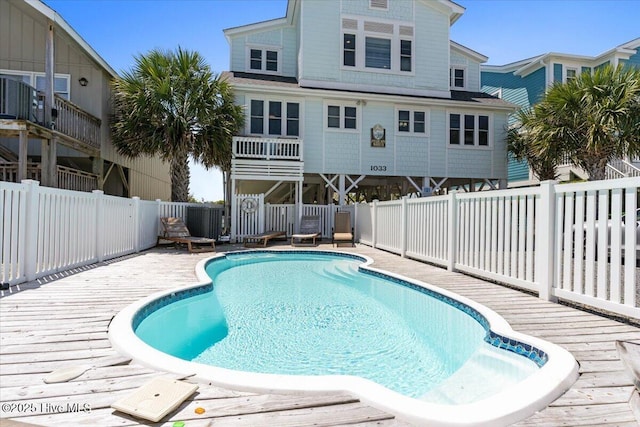 1033 Ocean Blvd W, Holden Beach, NC 28462 - view of pool with a wooden deck and a fenced backyard