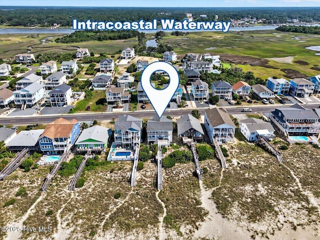1033 Ocean Blvd W, Holden Beach, NC 28462 - aerial view of residential area with a nearby body of water and a golf club