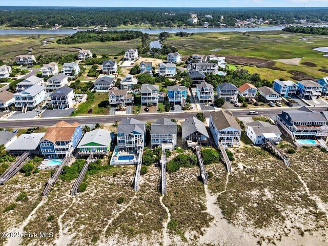 1033 Ocean Blvd W, Holden Beach, NC 28462 - aerial perspective of suburban area featuring a large body of water and a golf club